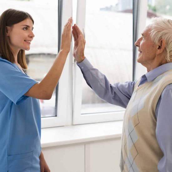 side-view-caregiver-high-fiving-with-old-man. from Freepik